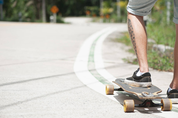 Young adult man with skate board on the road. High quality photo - Photo, Image