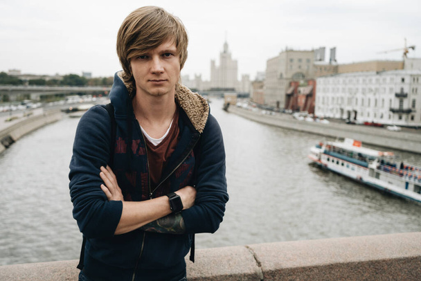 Blonde man is standing on the bridge in Moscow. High quality photo - Fotoğraf, Görsel