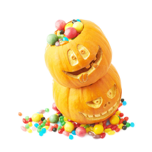 Two Halloween pumpkins filled with candies - 写真・画像