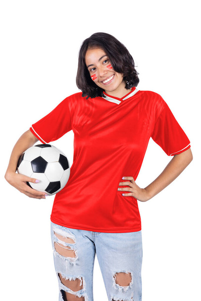 Young soccer fanatic woman with Switzerland sports jersey and ball in his hands, happy for the victory of his favorite team. - 写真・画像