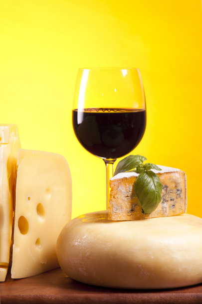 Cheese, wine and other tasty stuff on wooden table - Photo, Image
