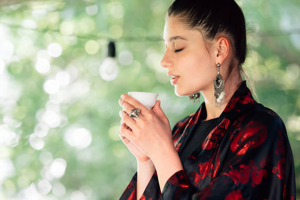 Shot of woman drinking from tea bowl, close view - Foto, Imagen