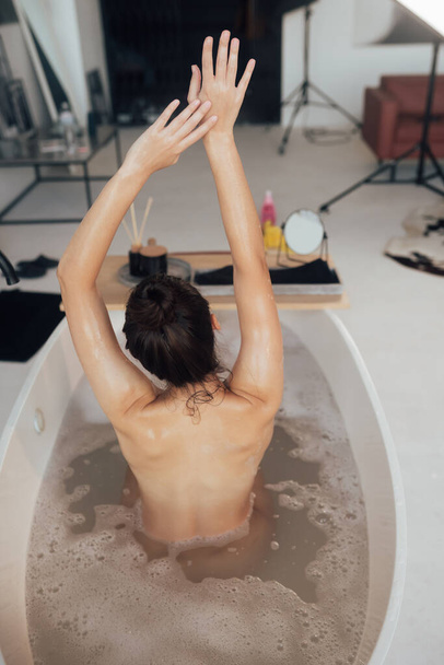 Pretty young woman taking bath at home - Foto, afbeelding