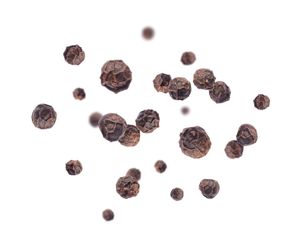 Pepper seeds in a random position in the air on a white background  - Фото, изображение