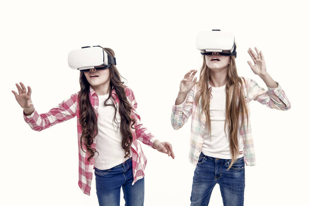 Future technology. Girls interact cyber reality. Play cyber game and study. Modern education. Alternative education technologies. Virtual education. Kids wear hmd explore virtual or augmented reality. - Foto, Bild