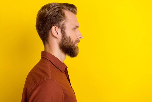 Profile side photo of good looking men after barbershop calm face trendy outfit look empty space isolated on yellow color background. - Foto, afbeelding