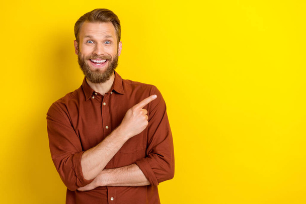Photo of handsome impressed speechless man blond beard wear burgundy shirt indicating empty space isolated on yellow color background. - Fotografie, Obrázek