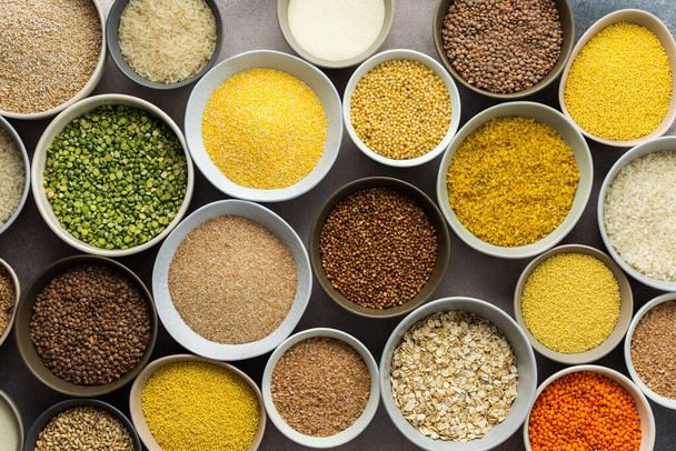 Various grain cereals in bowls on a light background, top view - Photo, Image