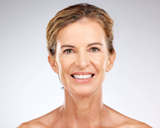 Face, beauty and skincare with senior woman happy with dermatology skin routine against mockup studio background. Cosmetics, antiaging and smile of lady posing for health, self love and wellness. - 写真・画像