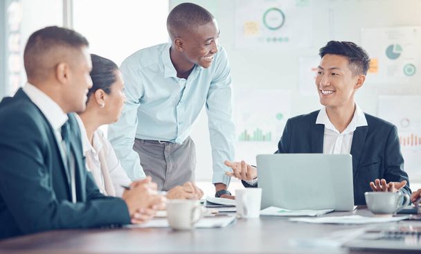 Smile, marketing and employees meeting, planning and working on a strategy for their startup business. Happy, corporate and training workers talking about a partnership with a laptop in an office. - 写真・画像