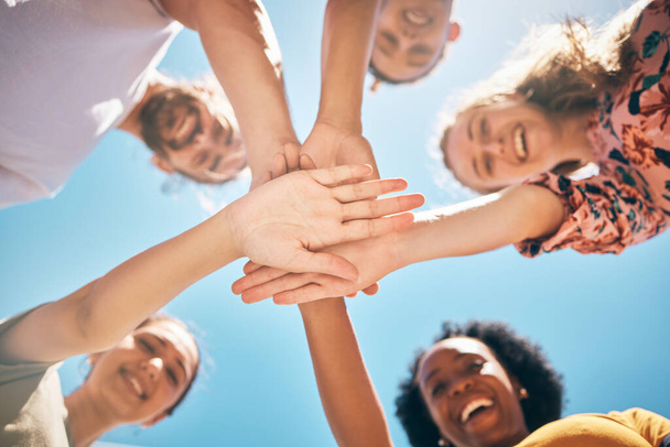 Hands, friends or support in community collaboration, trust or motivation for goals, success or solidarity. Low angle, huddle or circle of smile or happy people, men or women in diversity celebration. - Foto, imagen