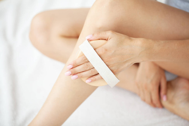 Женщина массирует кожу ног кисточкой - Фото, изображение