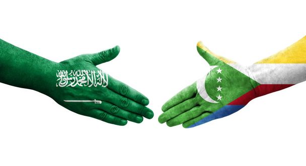 Kädenpuristus Komorien ja Saudi-Arabian välillä käsin maalatut liput, eristetty läpinäkyvä kuva. - Valokuva, kuva