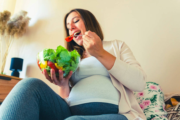 Pregnant woman eating healthy food. Happy pregnancy mother eating nutrition diet salad. Healthy breakfast food concept - Photo, image