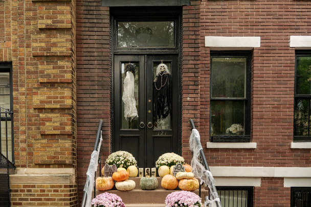 マンハッタンニューヨークのハロウィーンの休日のためのクモの巣で飾られたアパートの建物の前。高品質の写真 - 写真・画像