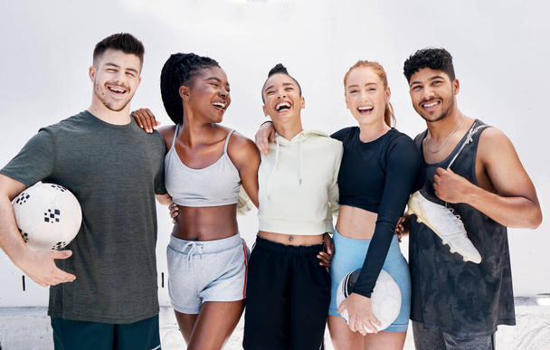 Fitness, soccer friends and diversity, a group of happy young people before a ball game. Smile, motivation and support, men and women with soccer ball ready for fun training exercise in the city - Фото, изображение