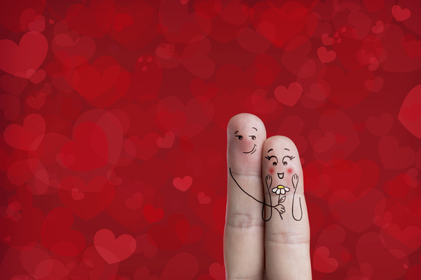 Finger art of a Happy couple. Stock Image. Man is embracing and giving flower. - Photo, Image