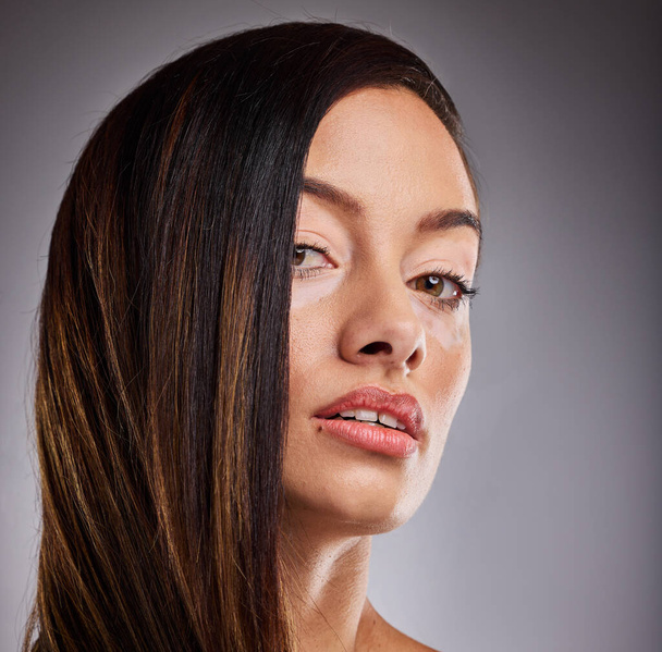 Skincare. beauty and vitiligo woman with cosmetics on face against studio background. Portrait of a young, pigmentation and cosmetic model with facial makeup, luxury dermatology and wellness or care. - Foto, Imagen