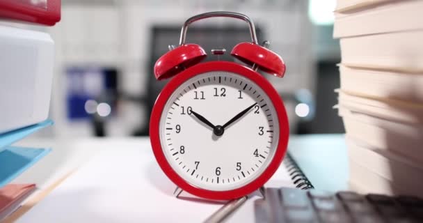 Alarm clock at 10 oclock and lot of folders of documents on table in office. Working time planning concept - Footage, Video
