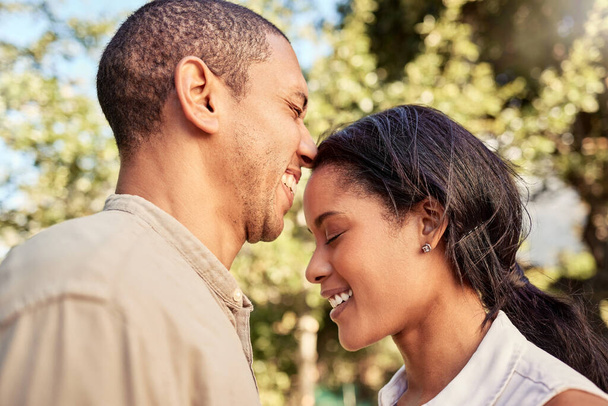 Love, black couple and being happy, smile and together bonding for relationship, marriage and outdoor. Romance, man and woman being joyful, happiness and loving for anniversary embrace and romantic - Photo, Image