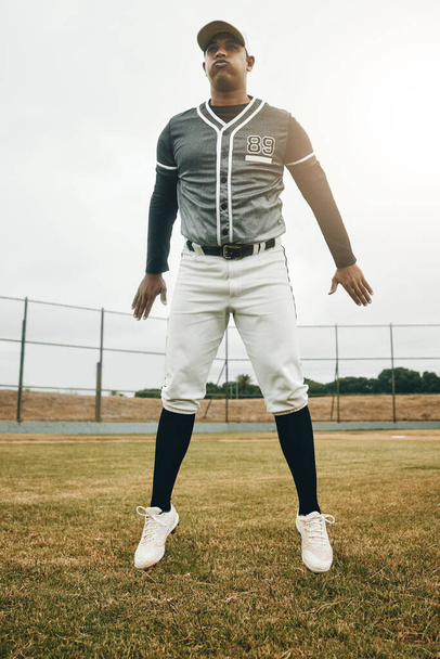 Jump on field, baseball player man on court and training for sports game performance in Houston. Softball exercise on grass, strong young club athlete and fitness on pitch in winter and fast energy. - Photo, Image