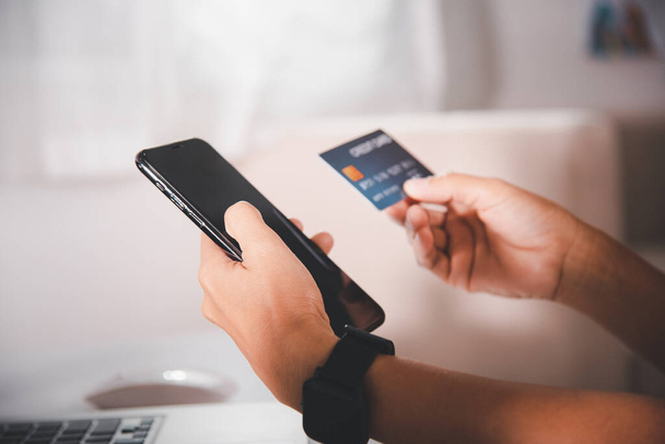 Woman hands holding credit card and smartphone with product purchase at home, Female register via credit cards on mobile phone to make digital payment security online, Internet online shopping concept - Valokuva, kuva
