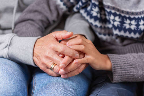 Senior woman and a child holding hands together. Family, help, elderly care and support concept - Photo, Image