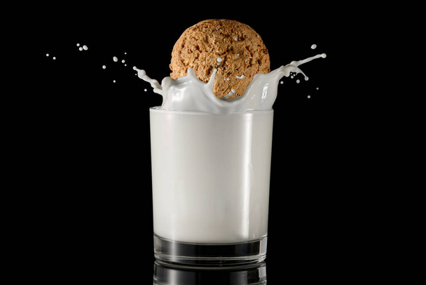 A glass of milk with sprinkles and an oatmeal cookie. - Foto, immagini