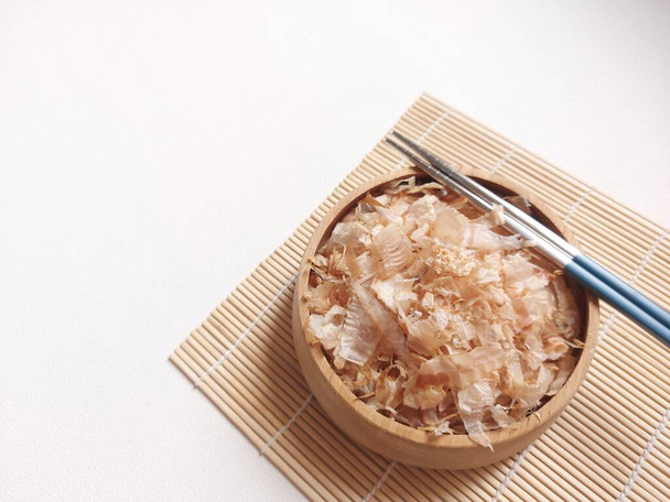 Katsuobushi. Je to konzervované jídlo vyrobené z tuňáka pruhovaného. oholený jako dřevěné hobliny na vývar. základ japonské kuchyně, sypané na vrcholu jídla jako příchuť. pojídáno jako vedlejší miska s rýží - Fotografie, Obrázek