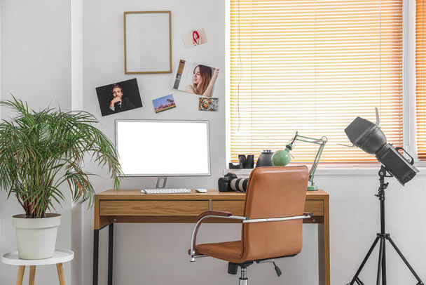 Photographer's workplace with computer and professional equipment in office - Photo, Image