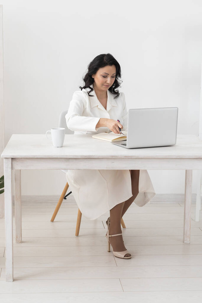 Portret zakenvrouw in wit pak die werkt op kantoor laptop computer. Kleine ondernemer mensen werknemer freelance online sme marketing e-commerce telemarketing - Foto, afbeelding