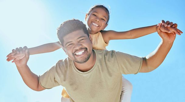 Father, child and holding hands on shoulder for happy relationship, bonding and smile in the outdoors. Portrait of dad and kid smiling in happiness for love, blue sky or care for piggyback in nature. - Фото, изображение