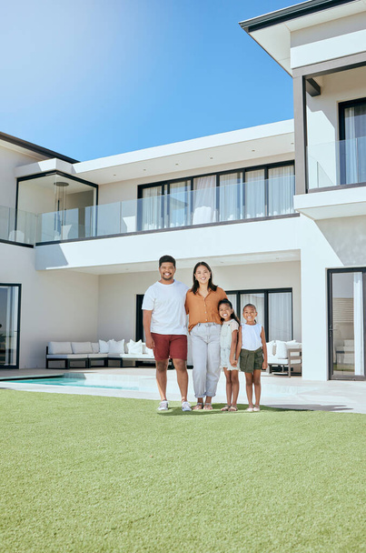 Portrait, real estate and happy family moving into their new luxury home, house or property in summer. Happy parents and children standing with a smile outdoor with building investment or purchase. - Photo, Image