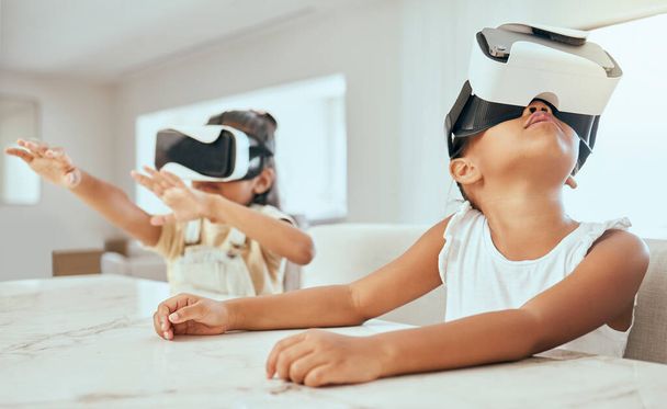 Vr, technology and children in their home, playing with headset on streaming videos, games and metaverse ux. Tech, 3d and kids with virtual reality goggles on for movies, gaming and futuristic fun. - 写真・画像