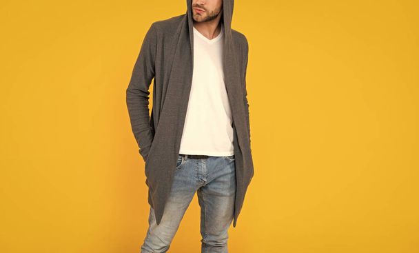 cropped young man in hood on yellow background. confident and handsome unshaven guy. male casual fashion. mens beauty. man with bristle. - Foto, Bild