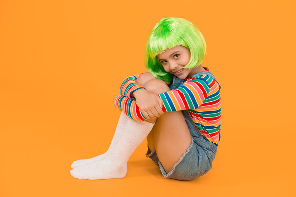 Kid girl with bright vibrant hairstyle. Artificial wig concept. Semi permanent color cream. Colored clip in hair extensions. Change color. Pigment dye hair. Freedom for expression. Fantasy hair trend. - Foto, Bild