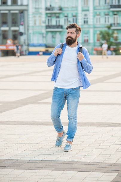 bearded man tourist walking outside. full length of tourist with beard. casual tourist outdoor. - Фото, изображение