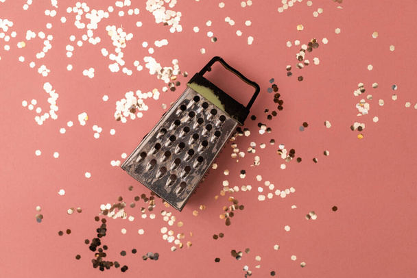 Vegetable and cheese grater on a pink festive background - Photo, Image