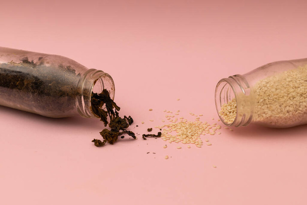 Spices in glass jars on a pink background - Photo, image