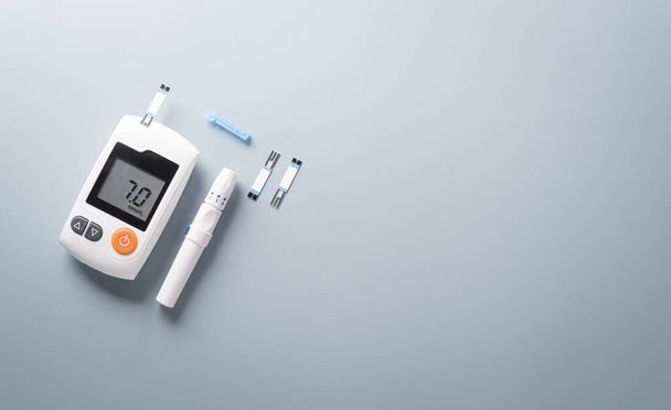 World Diabetes day concept ,14 November. Top view of blood glucose meter sets  on pastel blue background. - Photo, Image