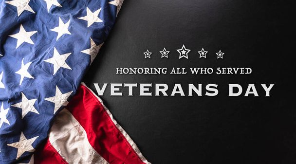 Happy Veterans day concept made from American flag and the text on dark wooden background. - Foto, Imagen