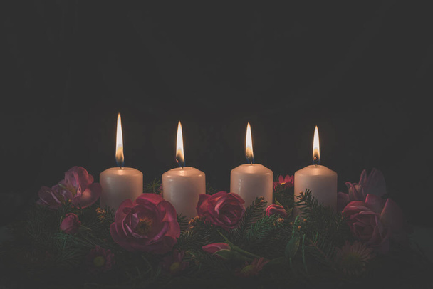 fourth burning advent candle on decorated rose flower pink advent wreath - Fotoğraf, Görsel