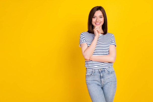 Photo of pretty sweet cheery lady wear nice striped outfit arm touch face bright grin stand empty space isolated on yellow color background. - Fotografie, Obrázek