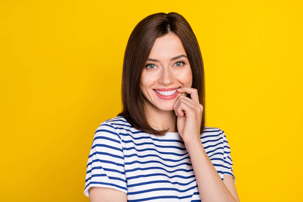 Photo portrait of pretty lovely young lady flirty bite finger smile treatment wear stylish striped look isolated on yellow color background. - Φωτογραφία, εικόνα