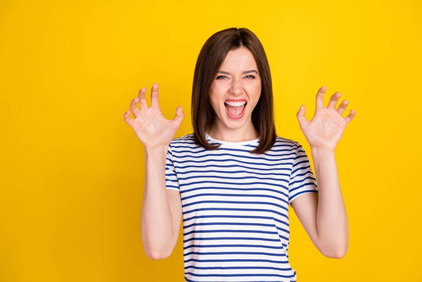 Photo portrait of funky young lady fooling show fingers claws growl tiger wear stylish striped garment isolated on yellow color background. - 写真・画像