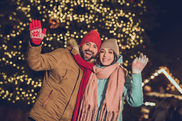 Portrait of cheerful excited partners arm waving hi enjoy late evening tree lights magic outside. - Fotoğraf, Görsel