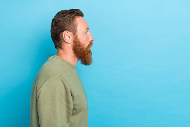 Side profile photo of bearded confident guy with ginger hairstyle khaki long sleeve look empty space isolated on teal color background. - Fotoğraf, Görsel