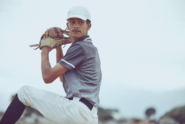Man, baseball and pitcher in sports throw or competitive match for point, score or win in the outdoors. Professional baseball player athlete in sport ready to pitch the ball on the field outside. - Fotoğraf, Görsel