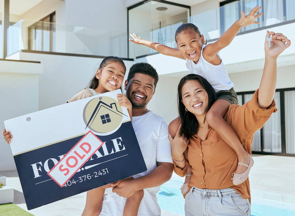 Family, sign and sold at new house in portrait, happy or smile for parents, kids or happiness. Asian, family and real estate with poster, sale or excited at property, home or mansion with children. - Photo, Image