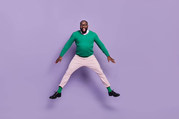 Full size photo of active cheerful overjoyed young man gentleman jumping up in excitement isolated on purple color background. - Фото, зображення